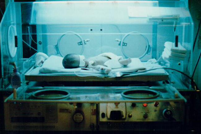 Hunter rests in an incubator as a newborn