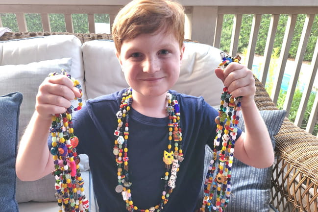 Joseph with his Beads of Courage. Each bead corresponds to an act of bravery, like an injection, X-ray, surgery or other significant milestone in Joseph’s treatment.