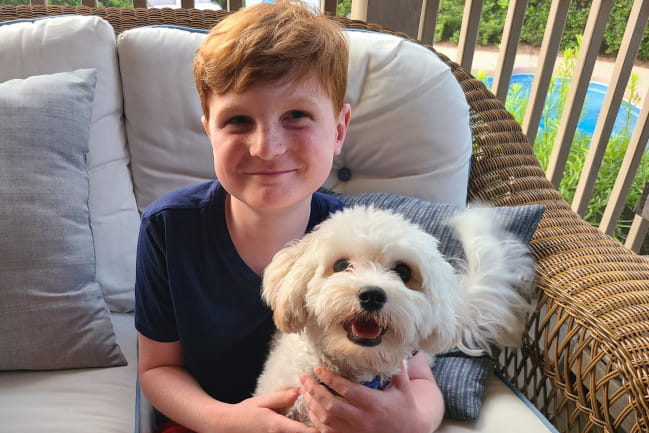 Joseph with his new puppy, Alex. Joseph loved Agnes so much, he “wished” for a puppy that could sit in his lap. The Make-A-Wish Foundation made it possible.